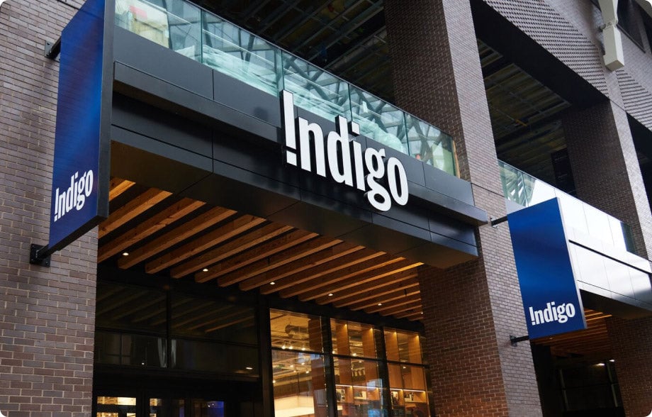 Indigo signs above the entrance to a glass-fronted bookstore