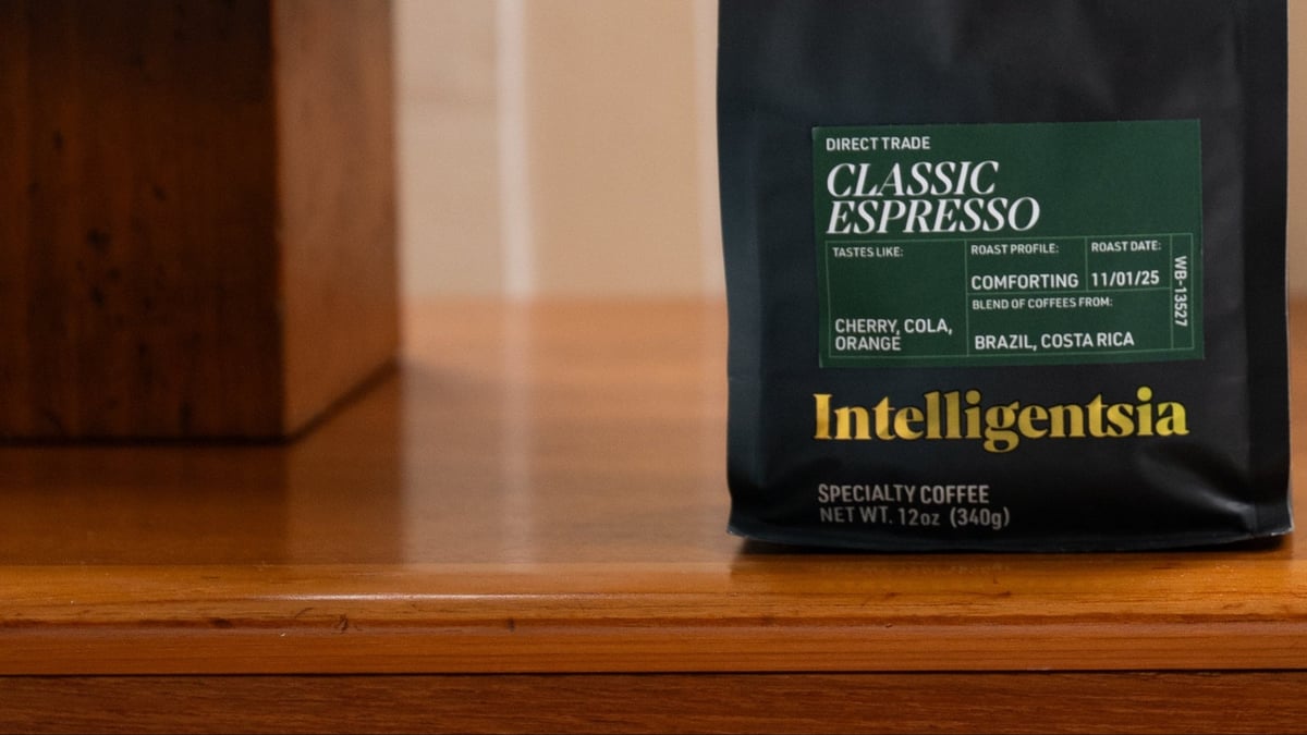 A black Intelligentsia Classic Espresso bag on a warm wood surface